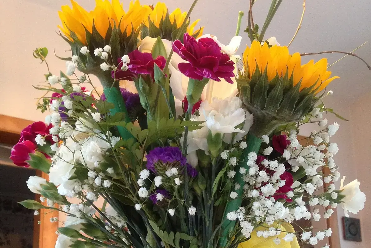 Flower vase waterline being cleaned while stems remain supported in fresh water