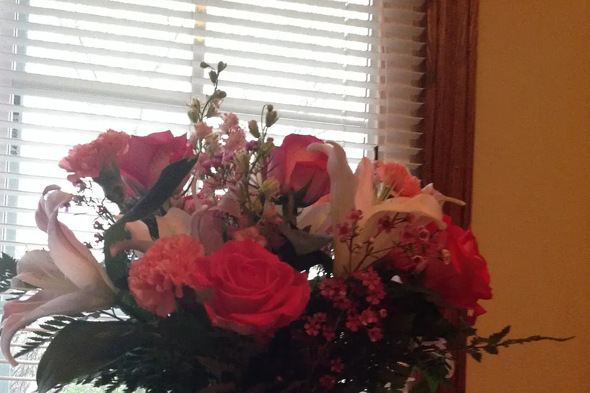 Small desk bouquet placed away from task light and keyboard traffic